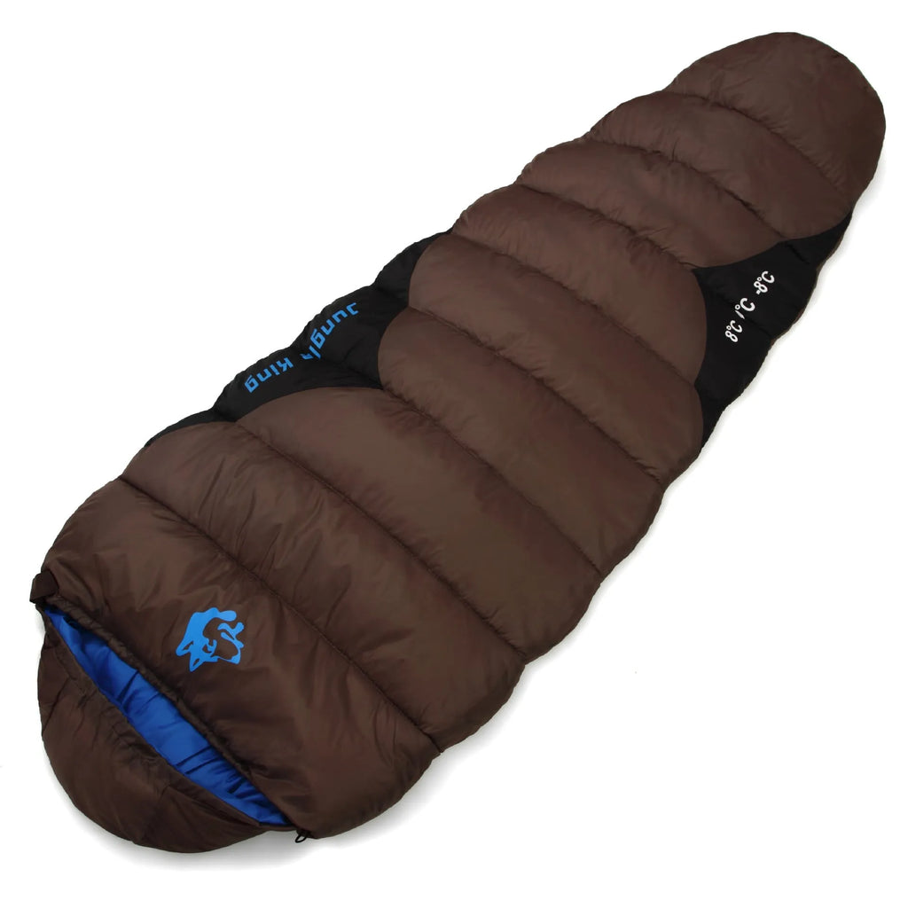 Outdoor cotton sleeping bag in army green with its compression sack, shown partially rolled.