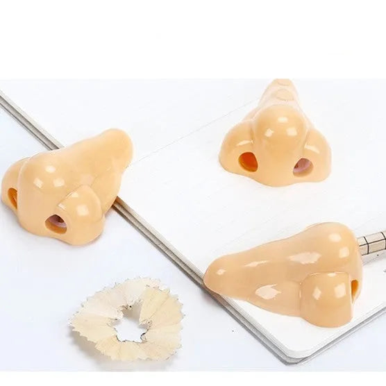 Flesh colour geometry plastic pencil sharpener with big nostril hole measuring 58x45x30mm