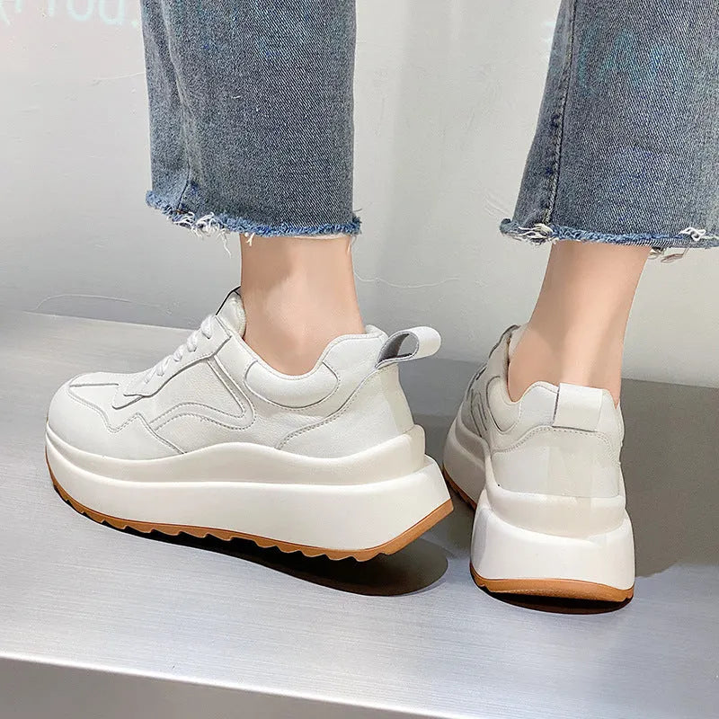 Women's beige low-top lace-up sports shoes made from cattlehide leather with a cross strap detail.