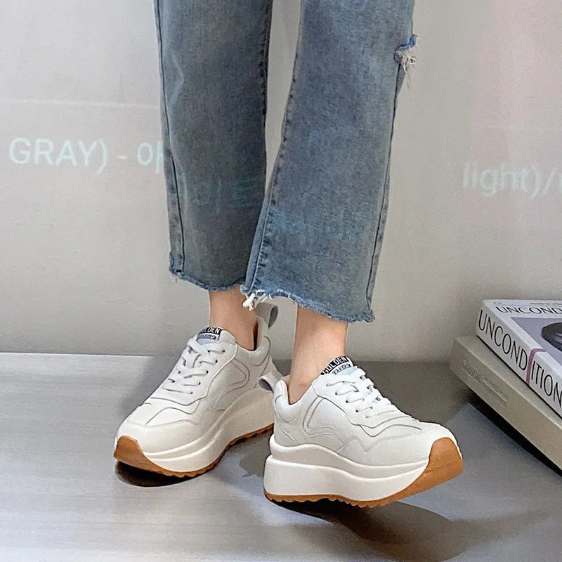 Women's beige low-top lace-up sports shoes made from cattlehide leather with a cross strap detail.