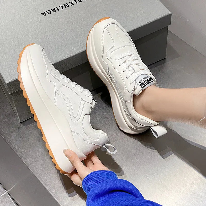 Women's beige low-top lace-up sports shoes made from cattlehide leather with a cross strap detail.
