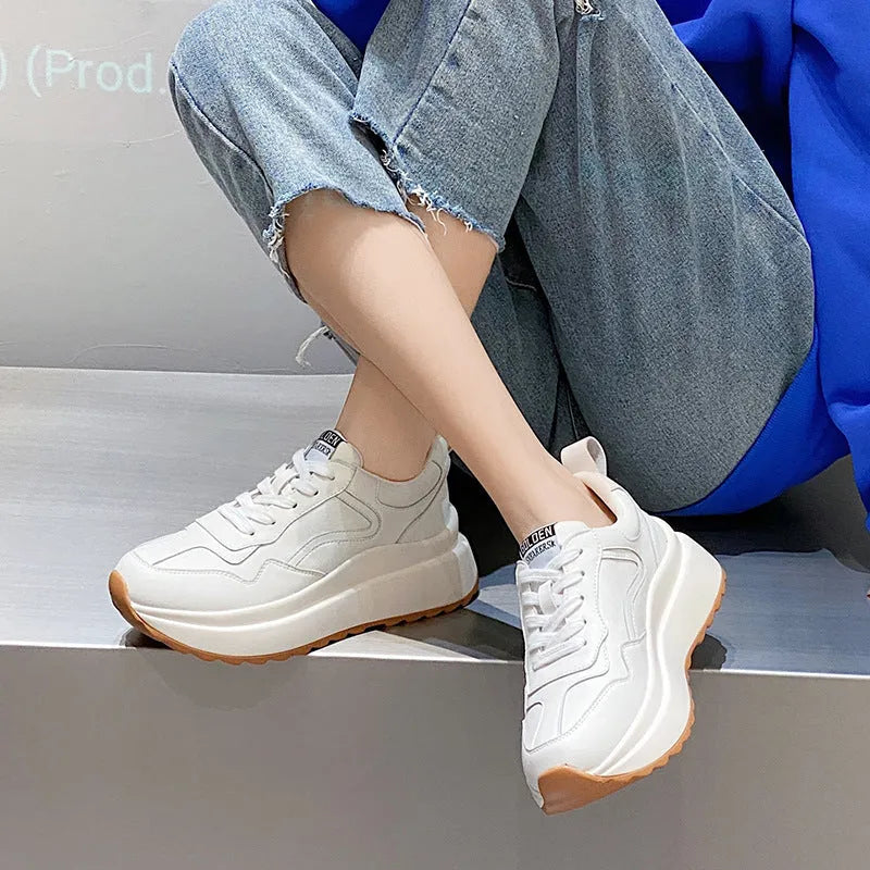 Women's beige low-top lace-up sports shoes made from cattlehide leather with a cross strap detail.