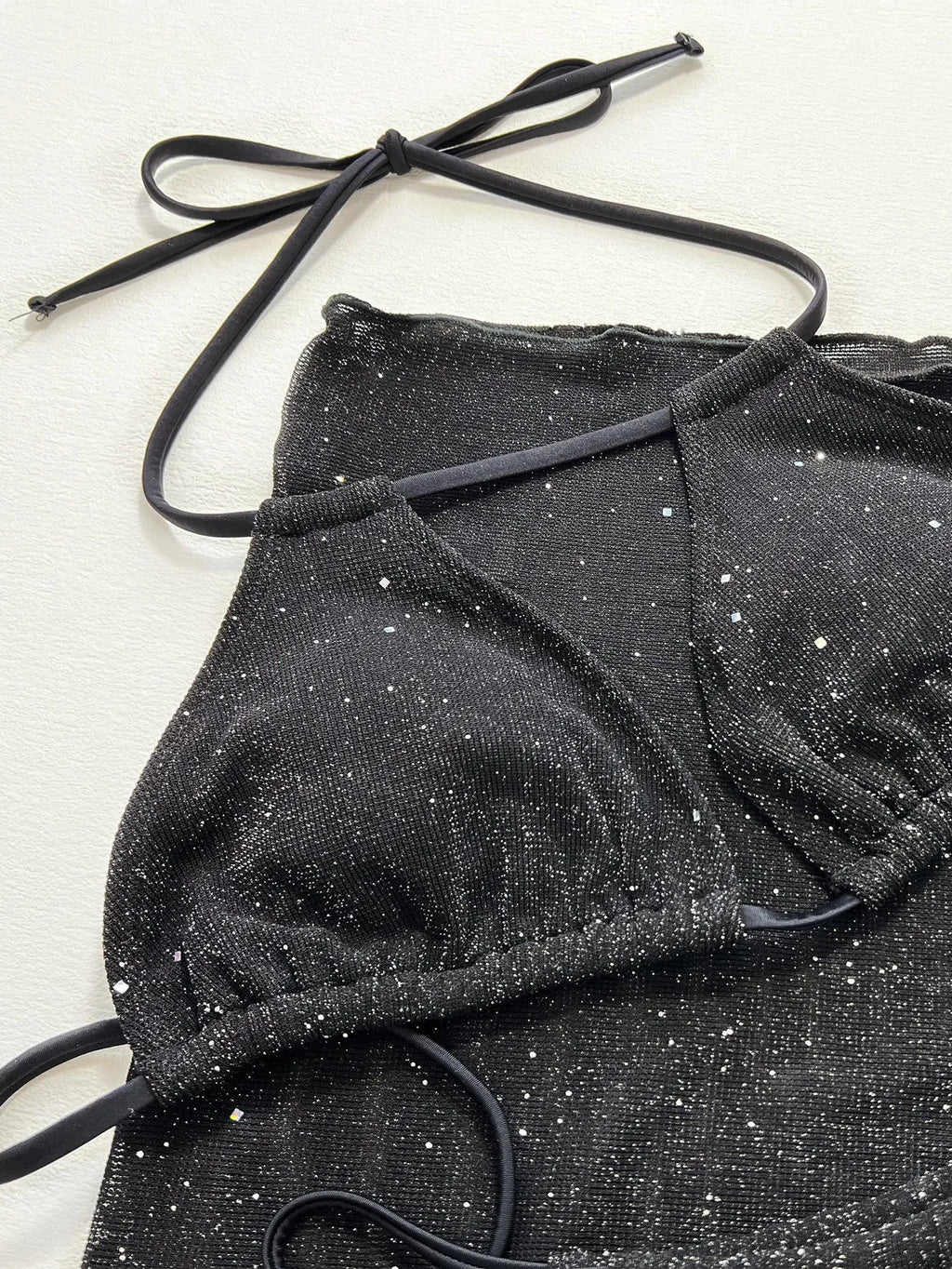 Black three-piece polyester bikini set with separate top and shorts
