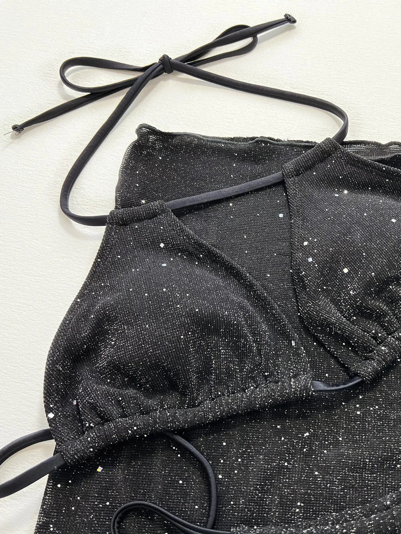 Black three-piece polyester bikini set with separate top and shorts