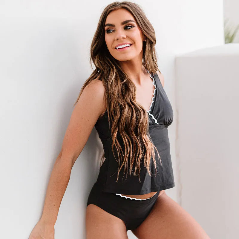 Black sleeveless one-piece split swimsuit for women on a mannequin