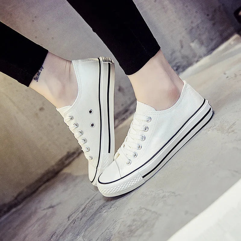 Women's solid colour canvas casual trainers in All Black, shown from the side on a white background.