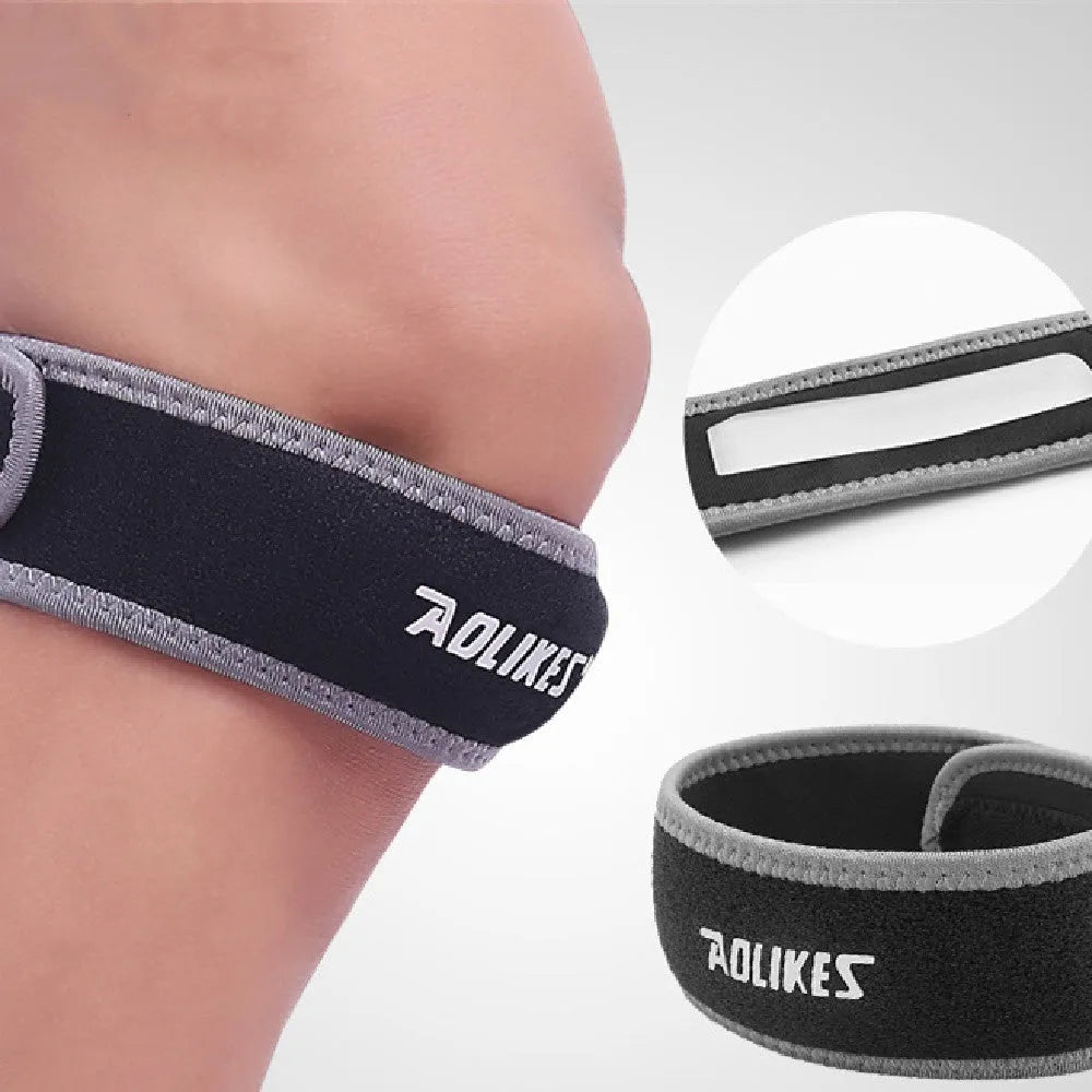 Black and grey patella retinaculum knee support for adult sports.