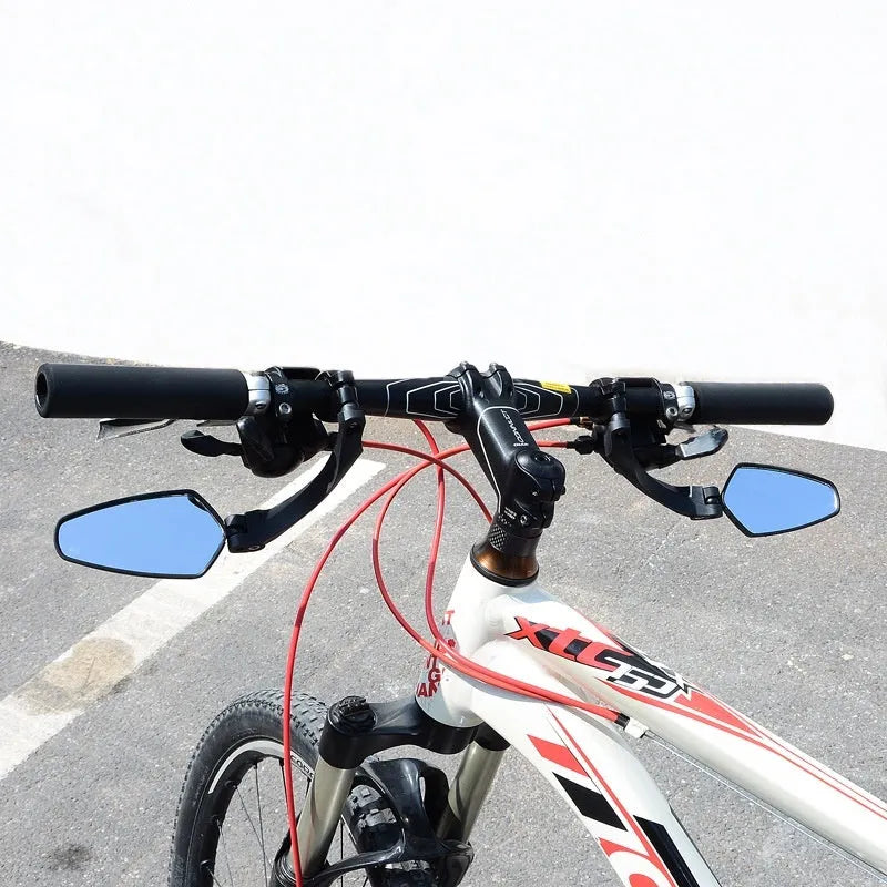 Black mountain bike rearview mirror with rotatable head mounted on bicycle handlebars showing 210mm acrylic surface