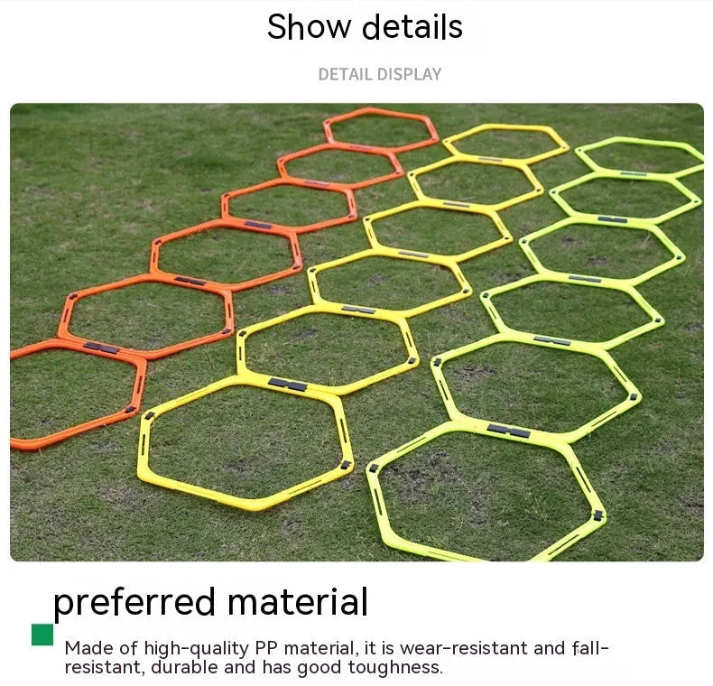 Set of six brightly coloured foldable hexagon football agility training rings on grass