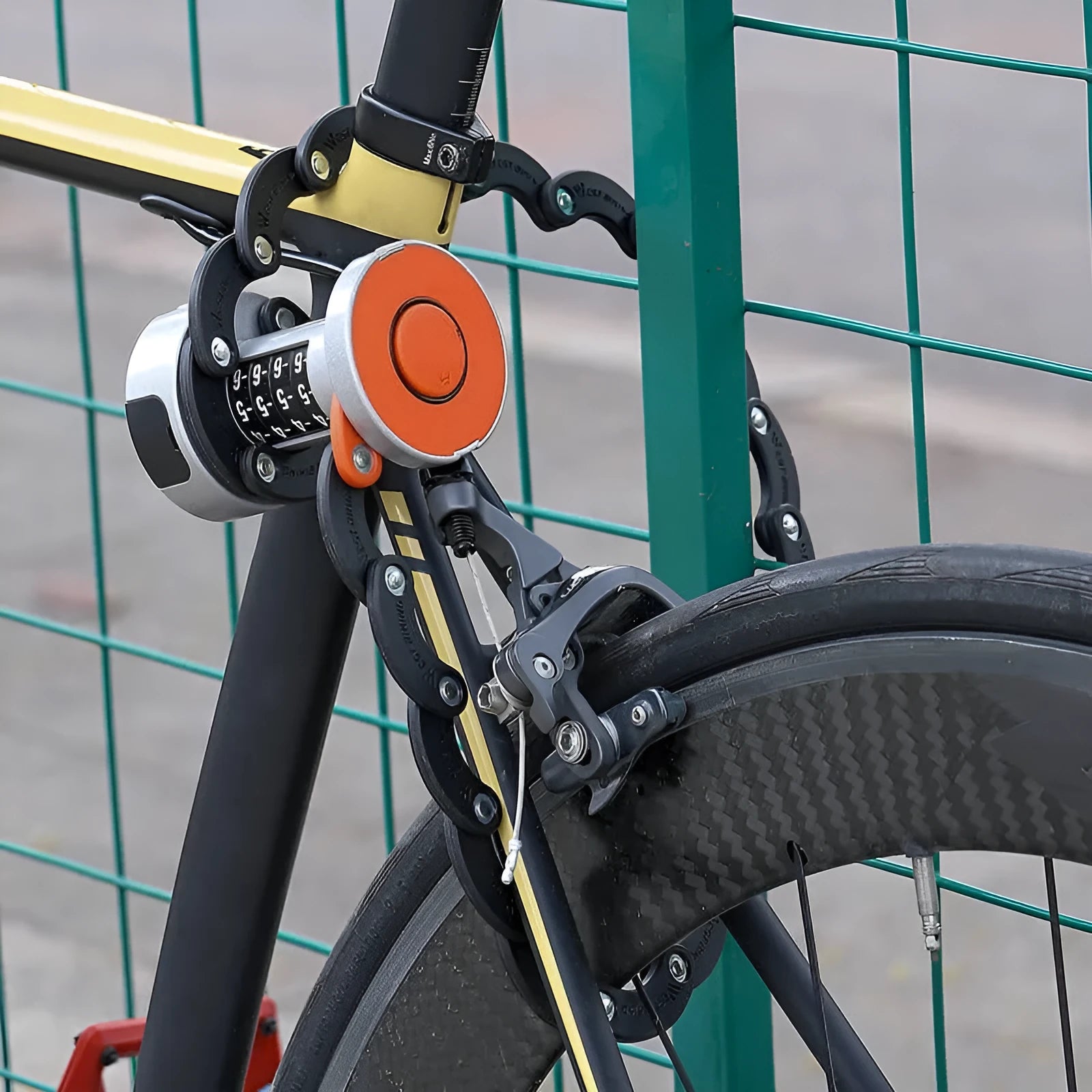 Portable black and orange bicycle folding lock in a compact, folded position.