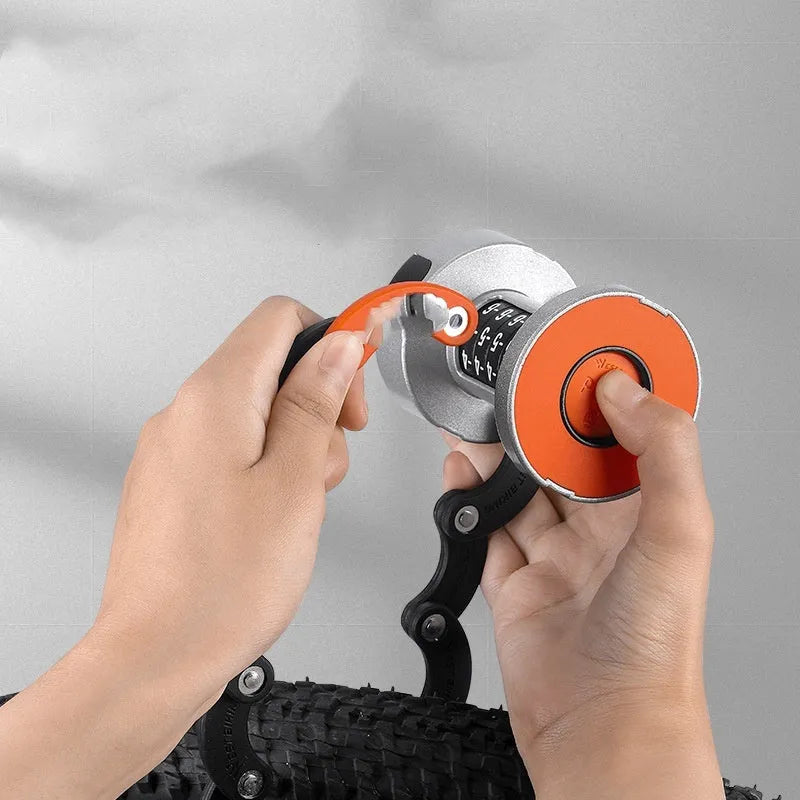 Portable black and orange bicycle folding lock in a compact, folded position.