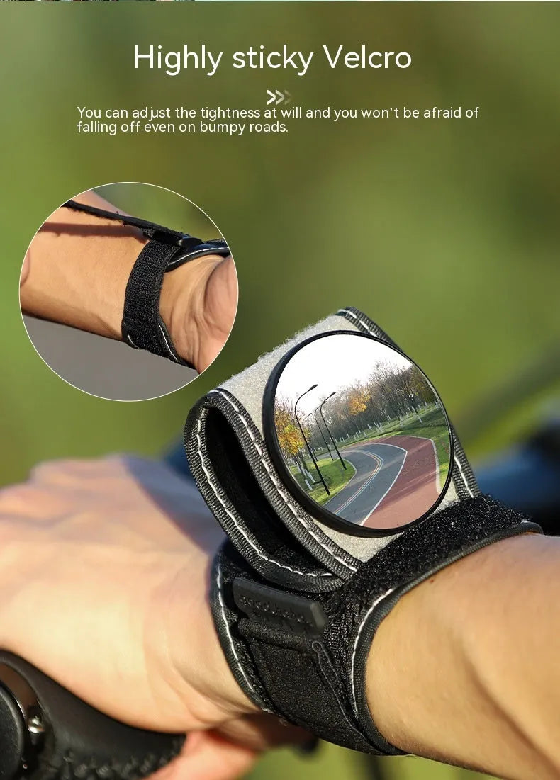 Black bicycle rear-view mirror mounted on an adjustable nylon wrist strap for cycling.
