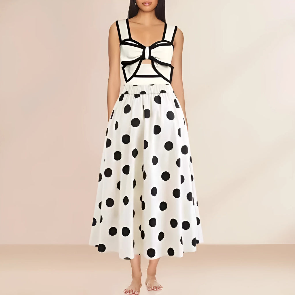 Women's black one-piece swimsuit with a white flared skirt and a central bow detail.