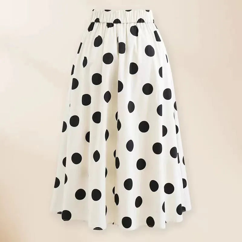 Women's black one-piece swimsuit with a white flared skirt and a central bow detail.
