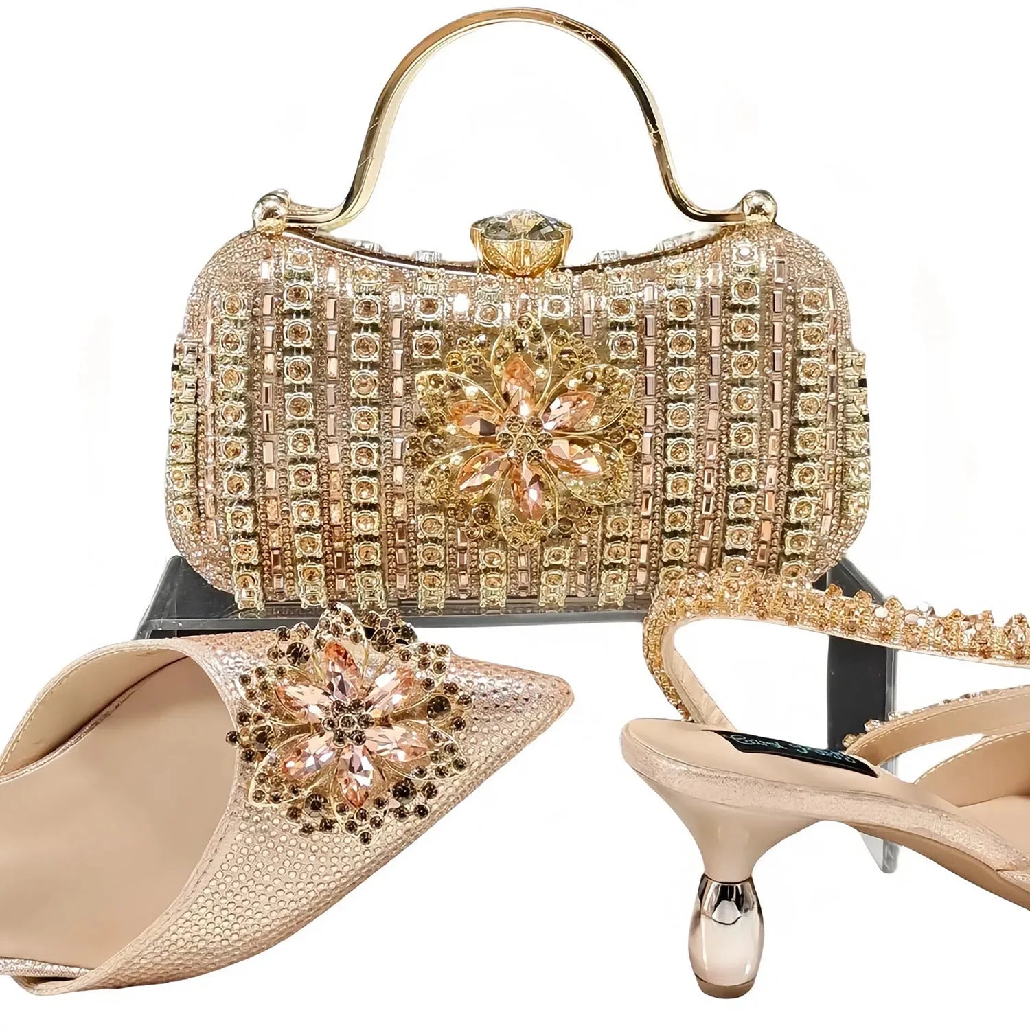 Women's black high heel and matching clutch bag set with rhinestone floral decoration and pointed toe.