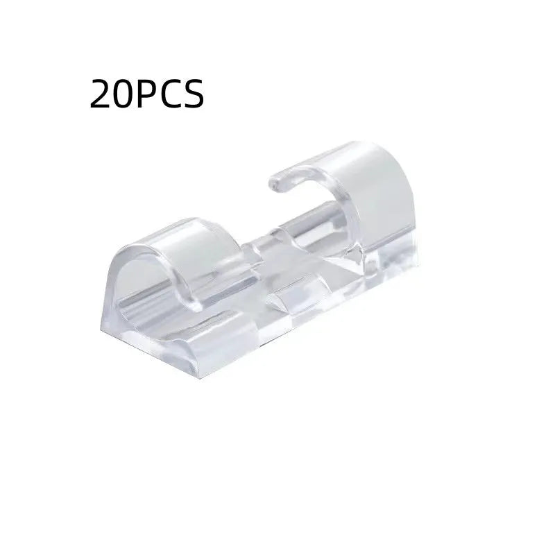 Transparent plastic self-adhesive cable clips for wire management on a desk.