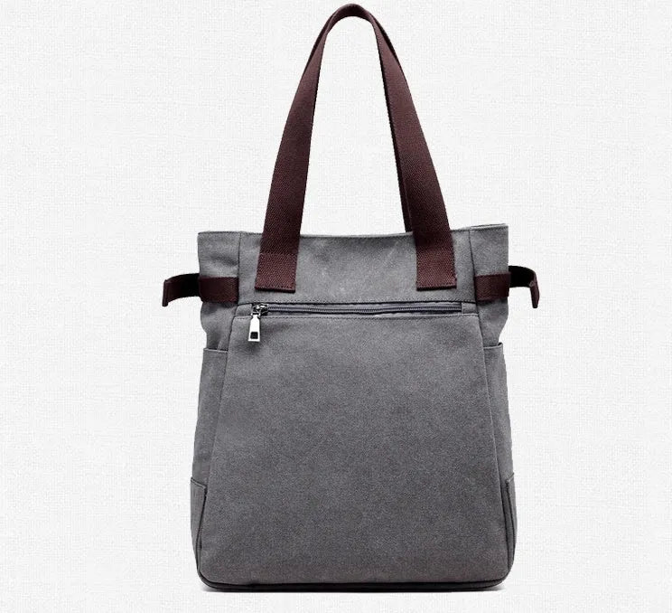 KVKY canvas handbag with plush cat applique in beige colour on a woman's shoulder