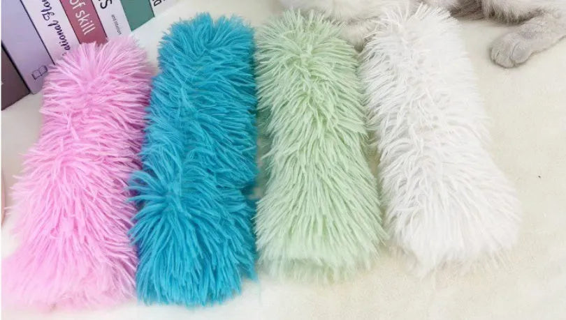 Cat plush toy pillow in blue, green, pink, and white colours measuring 27cm by 10cm