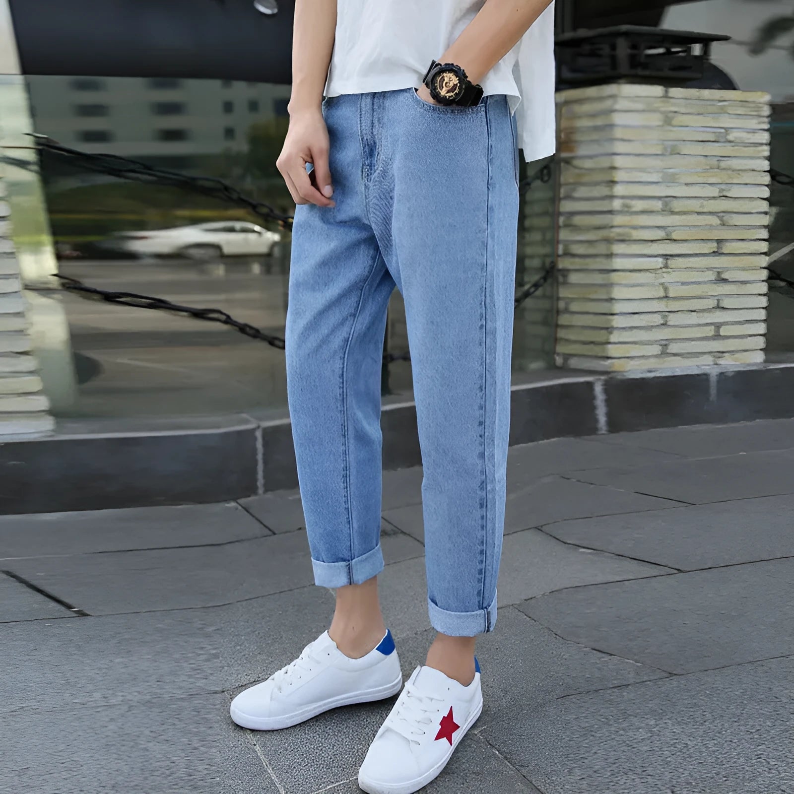 Man wearing black loose fit straight leg cotton jeans, showcasing the high-rise harem style and light straight leg opening.