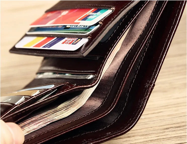 Men's leather wallet showing multiple compartments including banknote folder and card slots