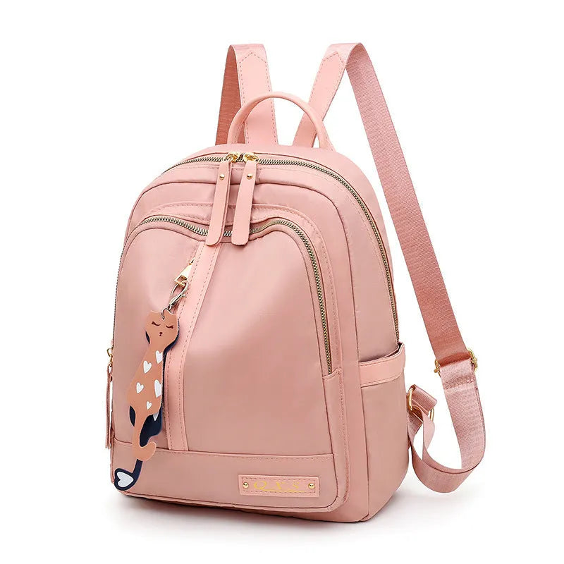 Black or pink women's casual nylon backpack with soft handle, showing internal zipper pockets and double shoulder straps.