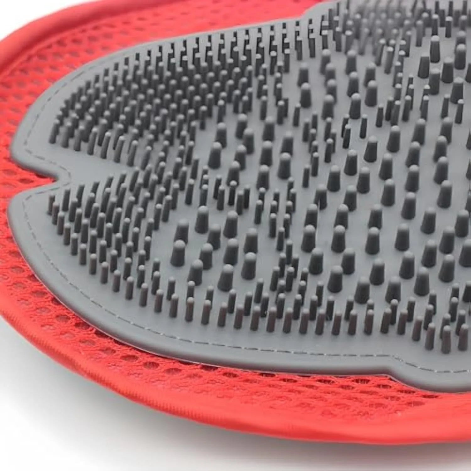 Red pet bathing and grooming glove with integrated brush, shown on a hand.