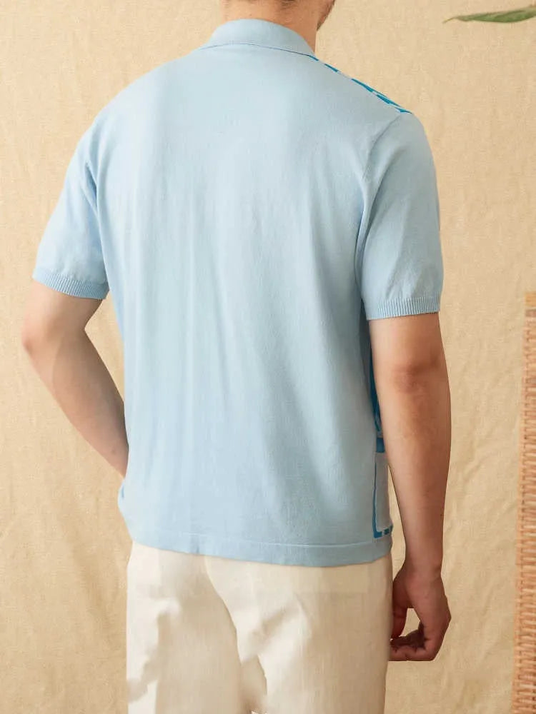 A man wearing a royal blue short-sleeved knitted polo shirt with a lapel collar.