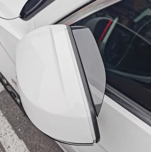 Pair of Mazda reversing mirror rain barrier strips in carbon fibre pattern on a Mazda CX5 side mirror
