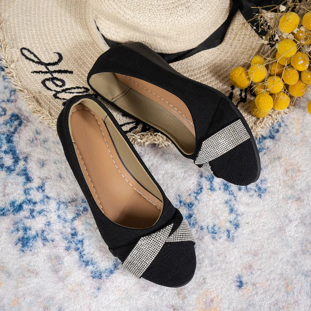 Women's black casual slip-on shoes with rhinestone detail, round toe, and a chunky heel.