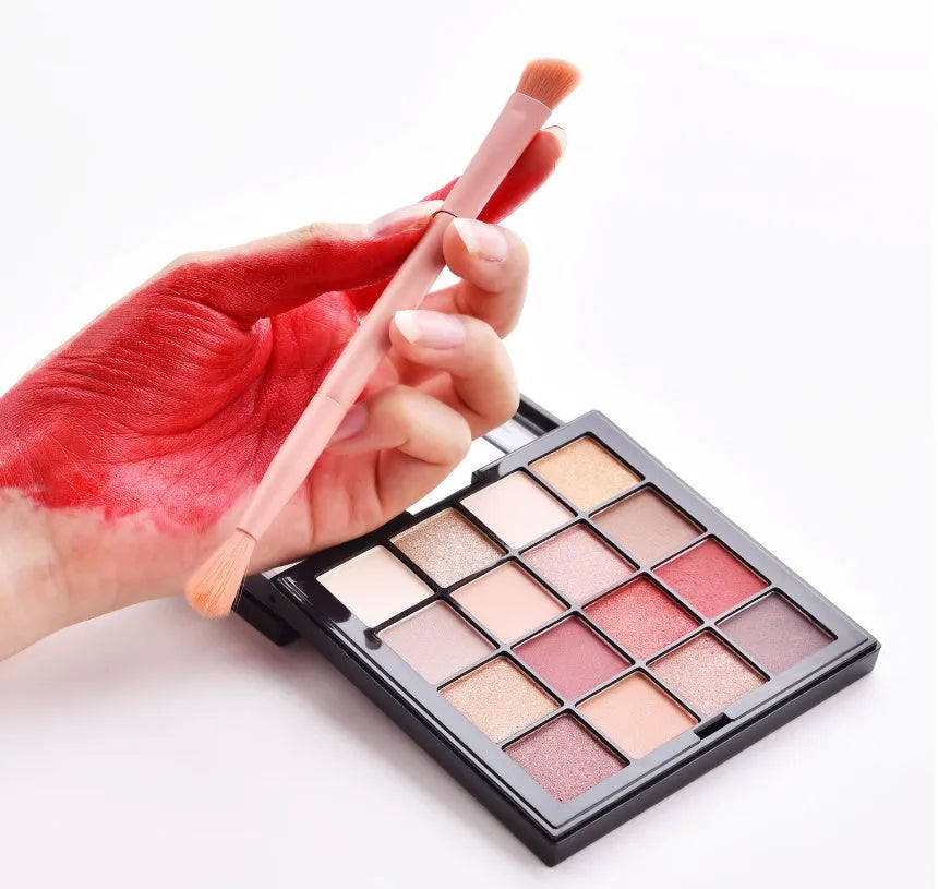 Ten professional makeup brushes with pink painted wooden handles and nylon bristles, including powder, foundation, and double-ended brushes.