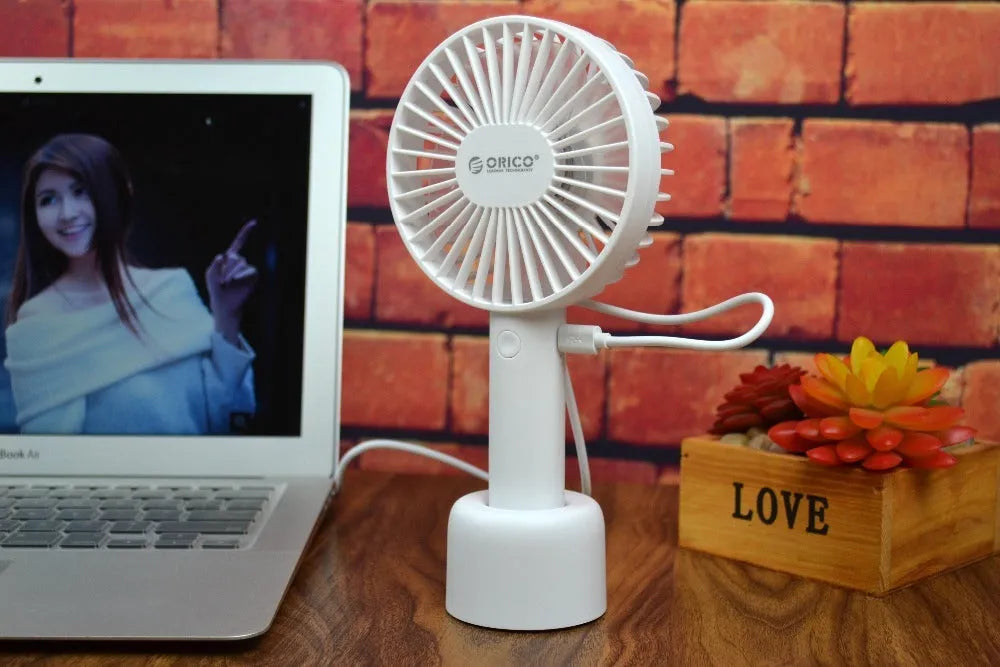 White ORICO FH1 portable USB rechargeable fan with fine line detailing, shown in handheld and desktop positions.