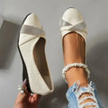 Women's black casual slip-on shoes with rhinestone detail, round toe, and a chunky heel.