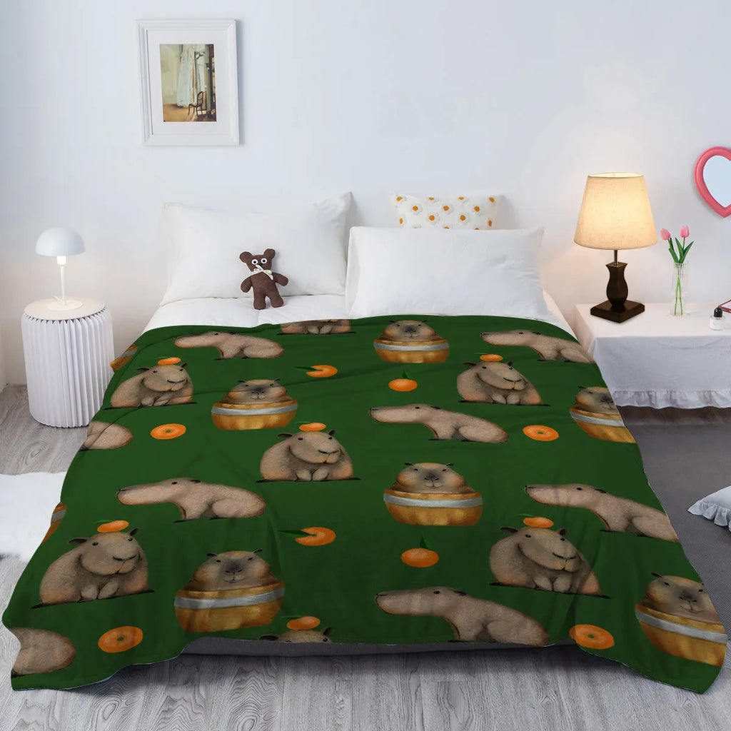 Flannel orange and capybara pattern soft fluffy multifunctional printed blanket on sofa