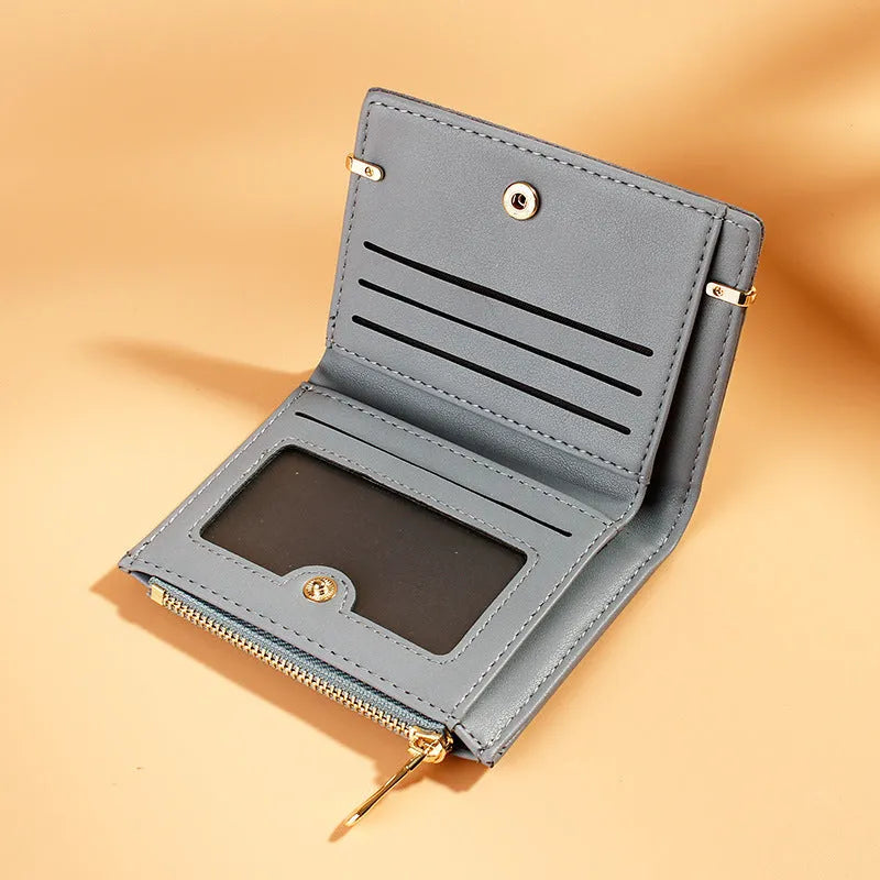 Short zipper ladies wallet in PU leather, open to show multiple card slots, bill holder, and change compartment.