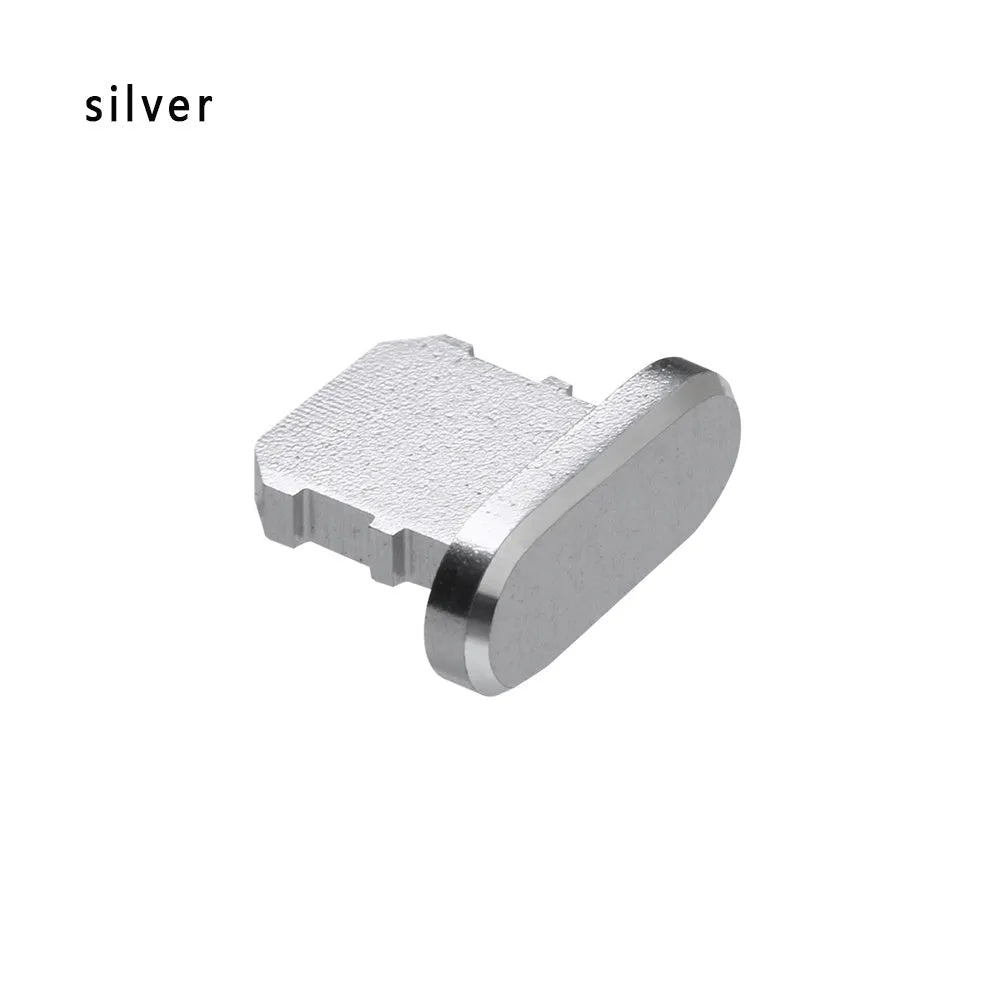 Aluminium alloy iPhone charging port dust plug in metallic colours on a dark background.