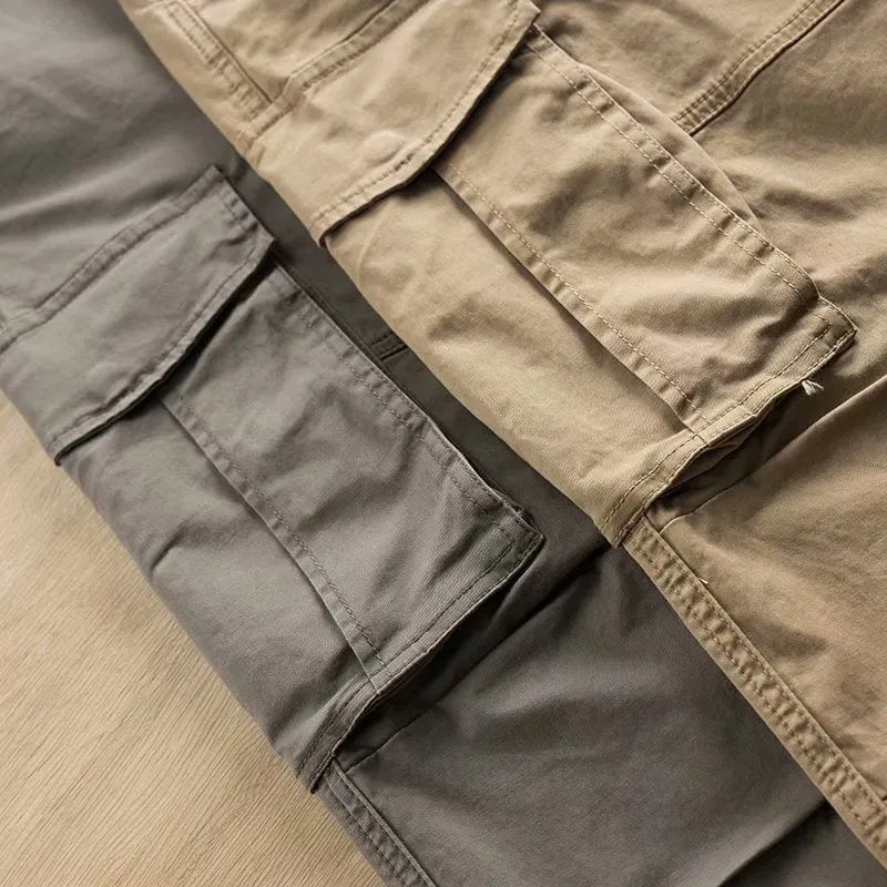 Men's multi-pocket cotton work trousers in cropped length showing cargo pocket design