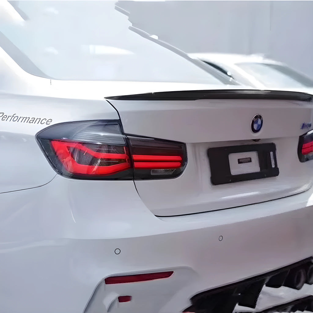 BMW 3 Series aftermarket tail light assembly with red lens and integrated streamer LED running light design.