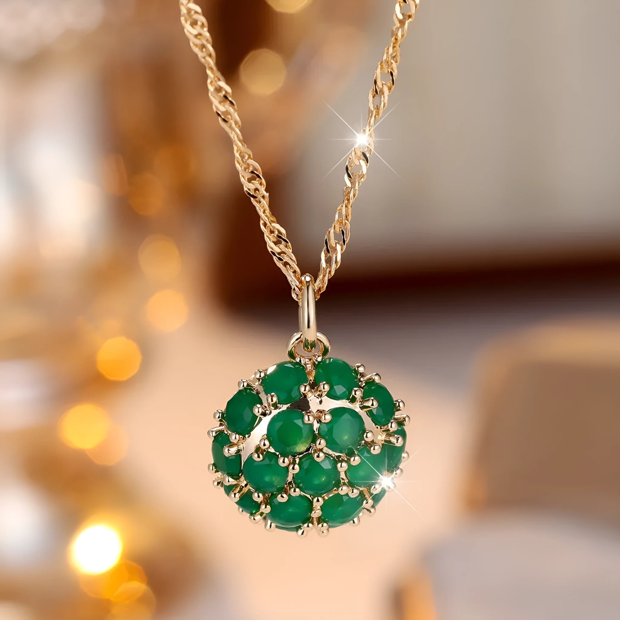 Geometric pendant necklace with emerald and diamond detailing on adjustable champagne gold chain