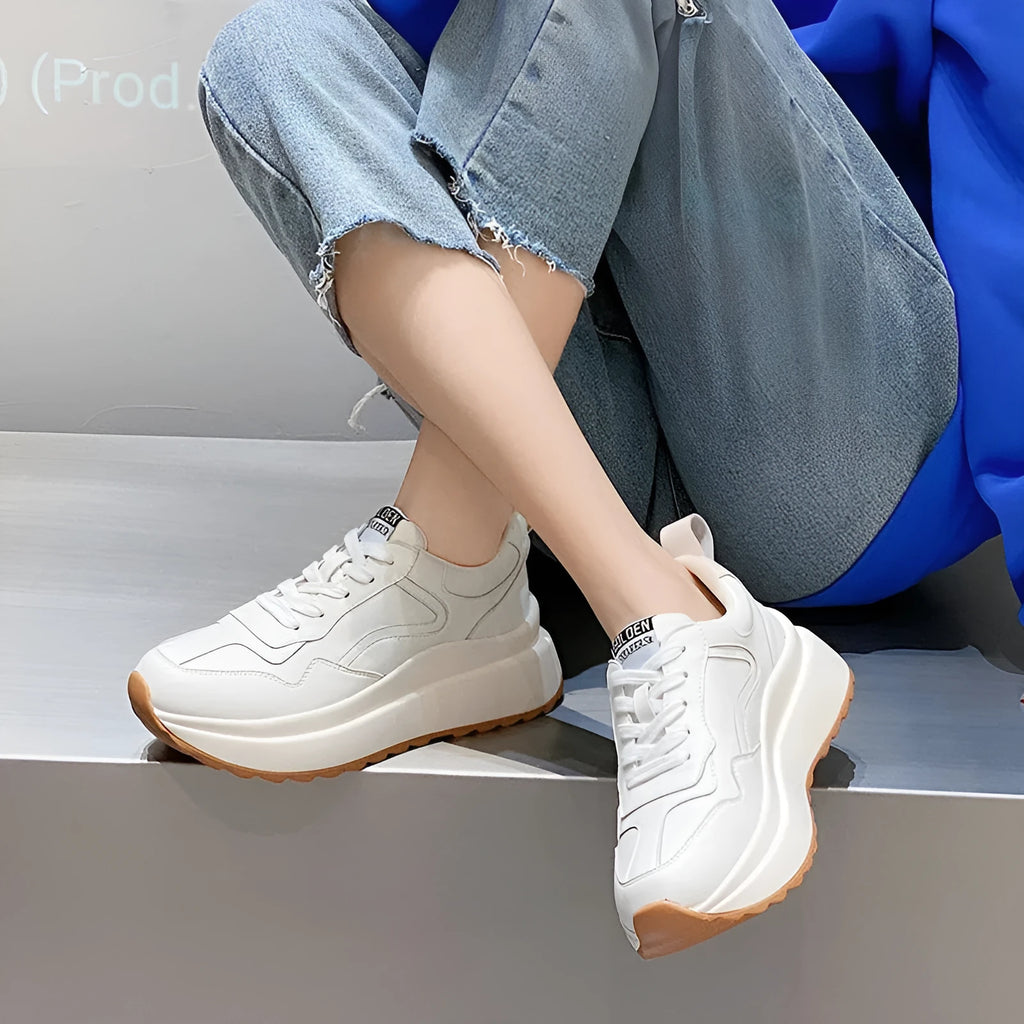 Women's beige low-top lace-up sports shoes made from cattlehide leather with a cross strap detail.