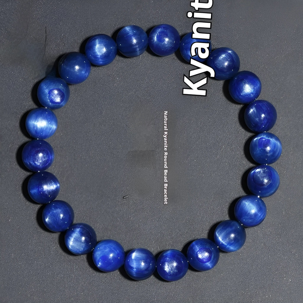 Polished blue crystal ball bracelet with geometric beads and Ruyi design on a white background.