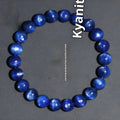 Polished blue crystal ball bracelet with geometric beads and Ruyi design on a white background.
