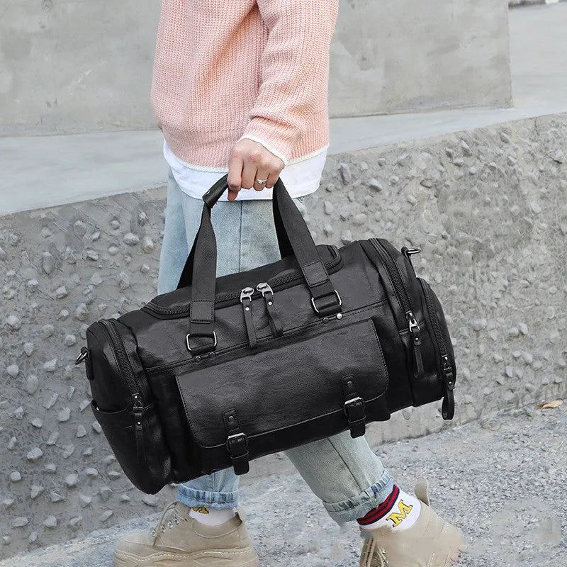 Large black travel bag with a separate shoe compartment, showing its size and durable PU fabric construction.