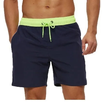 Men's blue athletic shorts with stitching waist detail and zipper pockets for running and fitness
