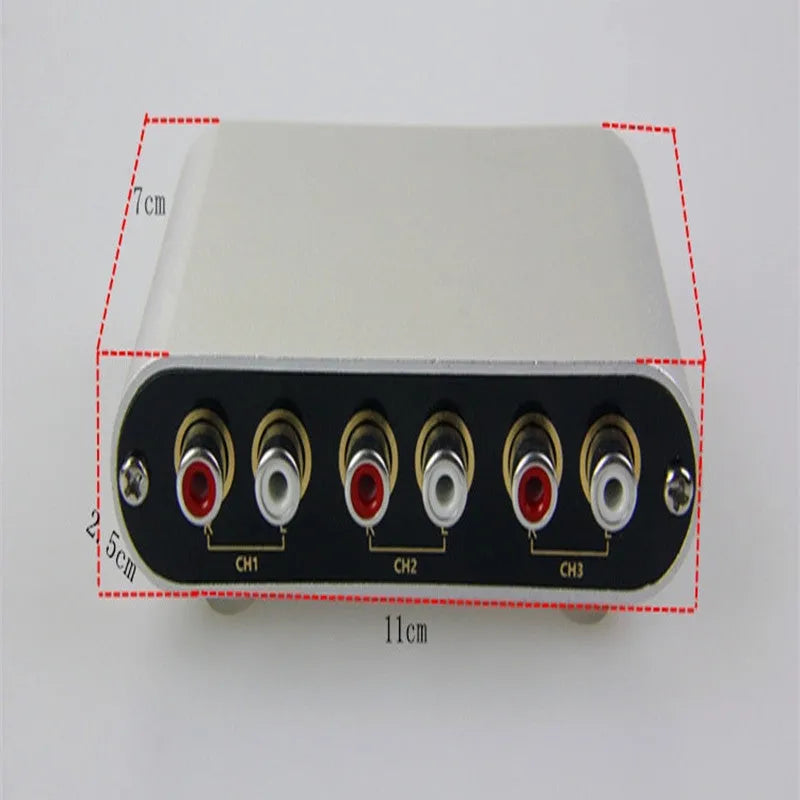 Silver aluminium audio source selector switch unit with front-panel buttons and infrared remote control.