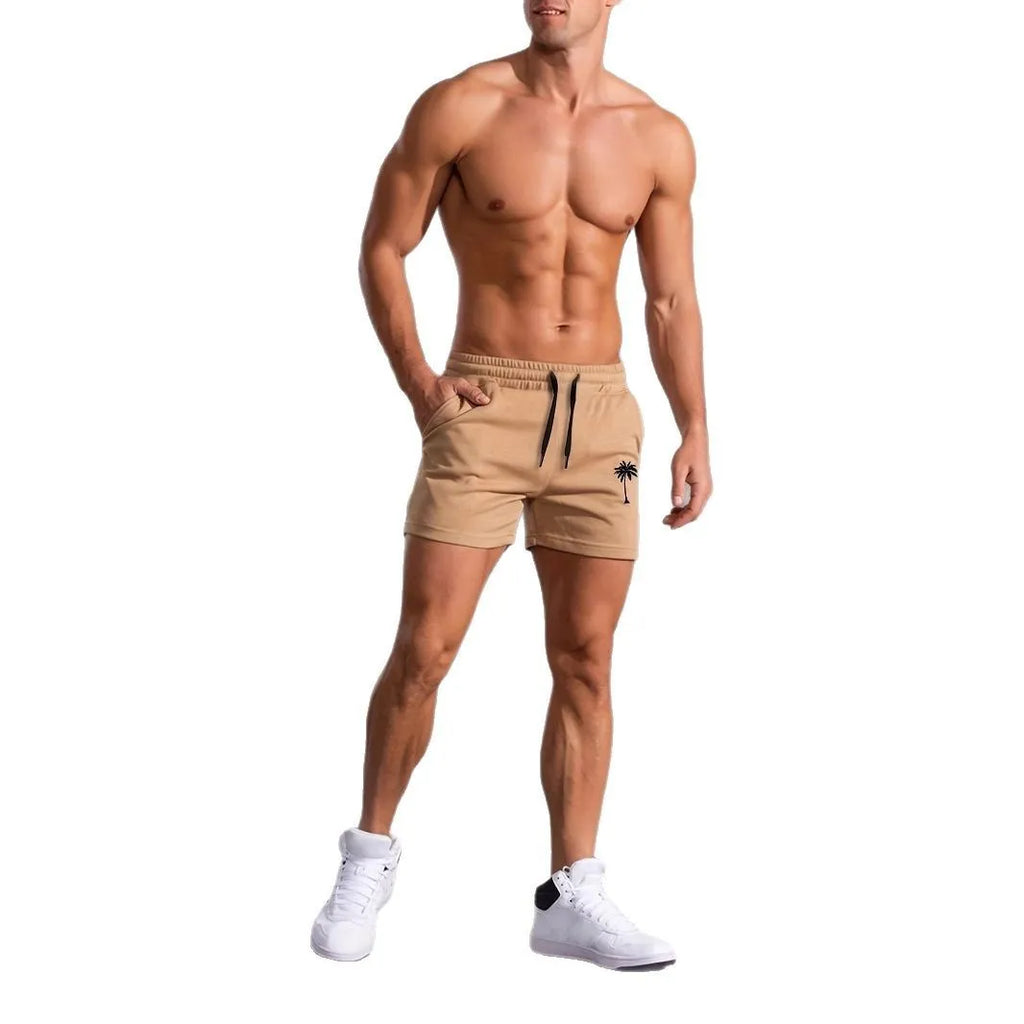 Men's khaki sports shorts with a coconut leaf pattern, showing a straight-leg fit and elasticated waistband.