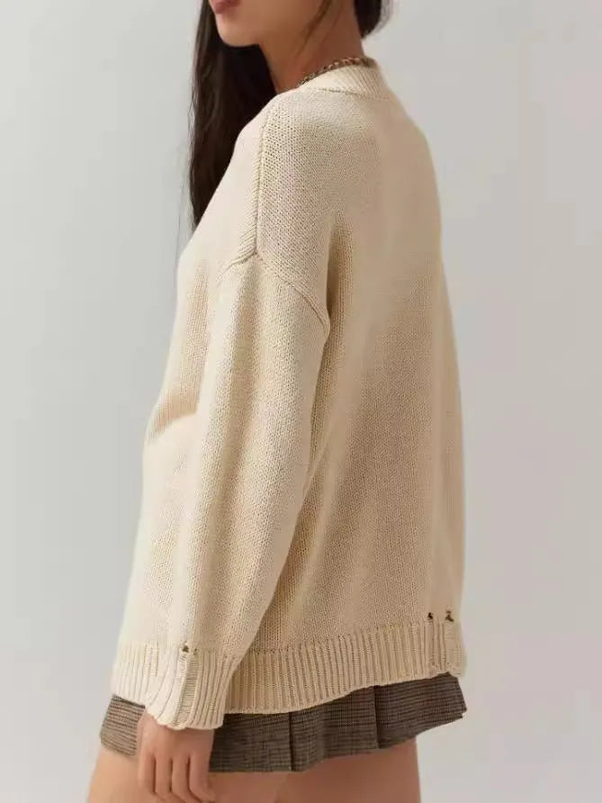 Women's milky white loose-fit acrylic jumper with jacquard knitting detail on front.