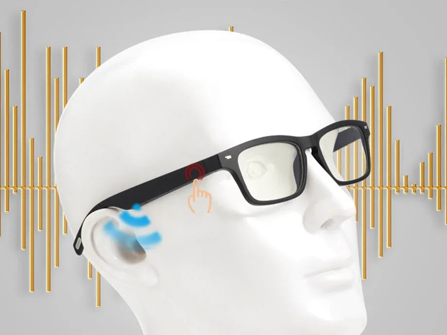 Black Bluetooth smart glasses with semi-open ear speakers and interchangeable lenses on a table with case.
