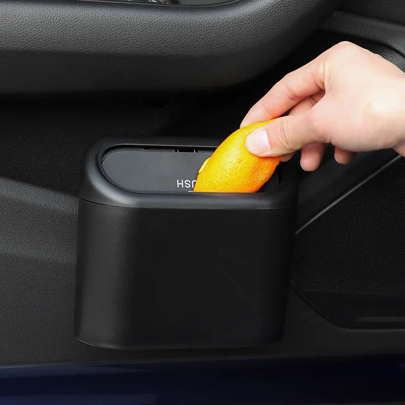 Black ABS car trash can with upturned lid and removable hook, 160x143x85mm, on car seat