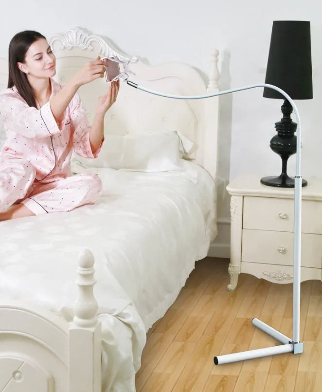 Black mobile phone bracket with universal folder attached to bed frame for hands-free viewing