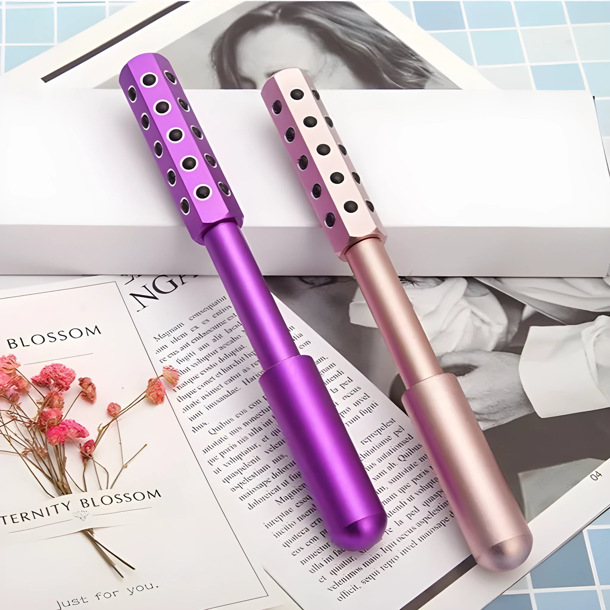 Purple handheld germanium particles facial massage roller on a white background.